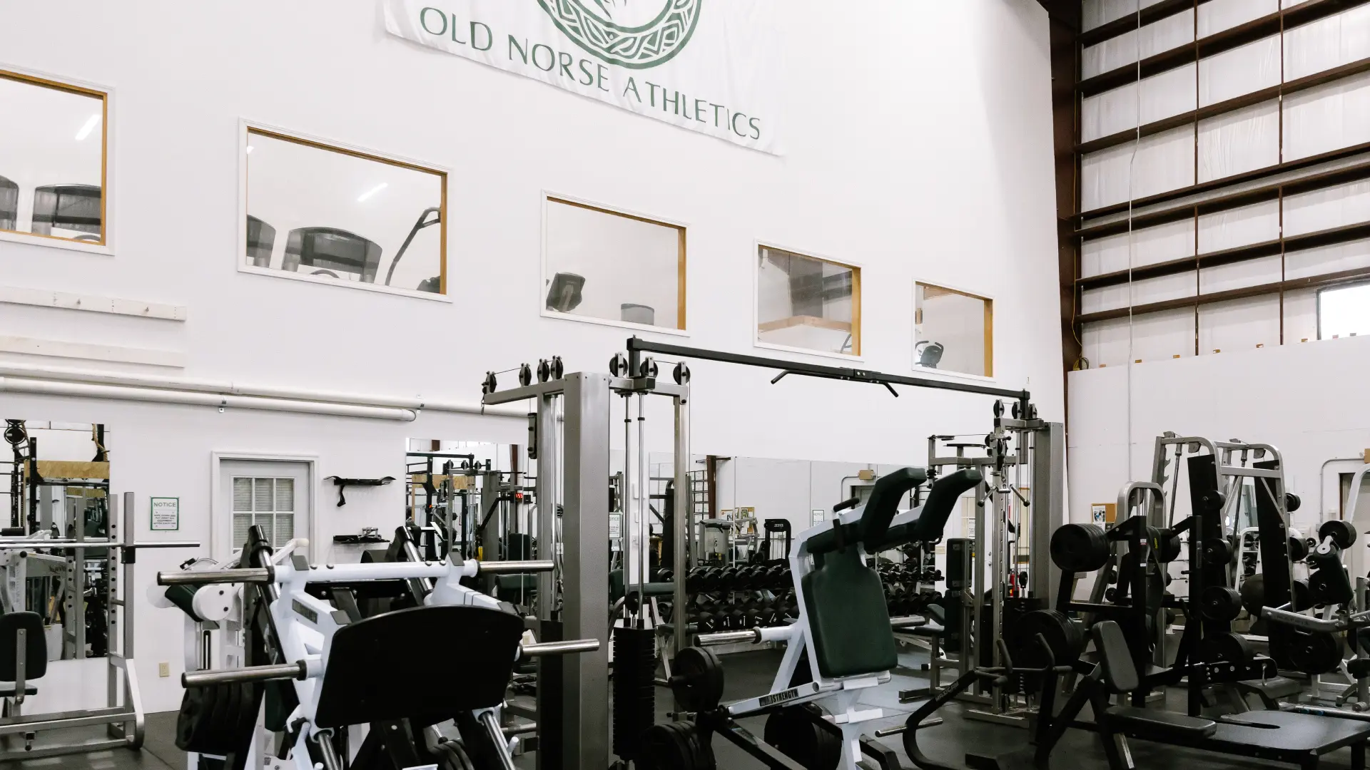 Plate-loaded machines and cable stations under the gym banner at O.N. Athletics in Groton, CT