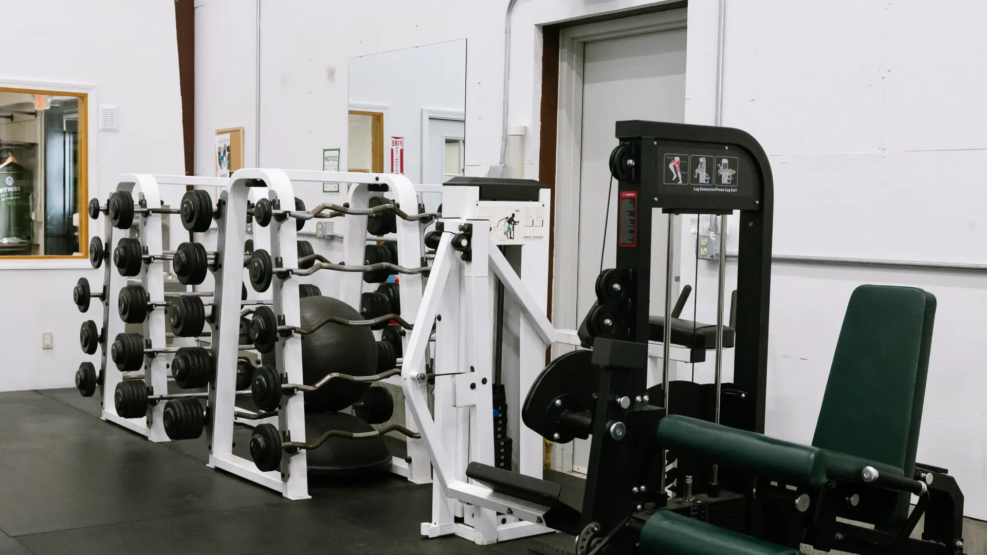 Barbell rack, EZ bars and leg extension machine at O.N. Athletics in Groton, CT