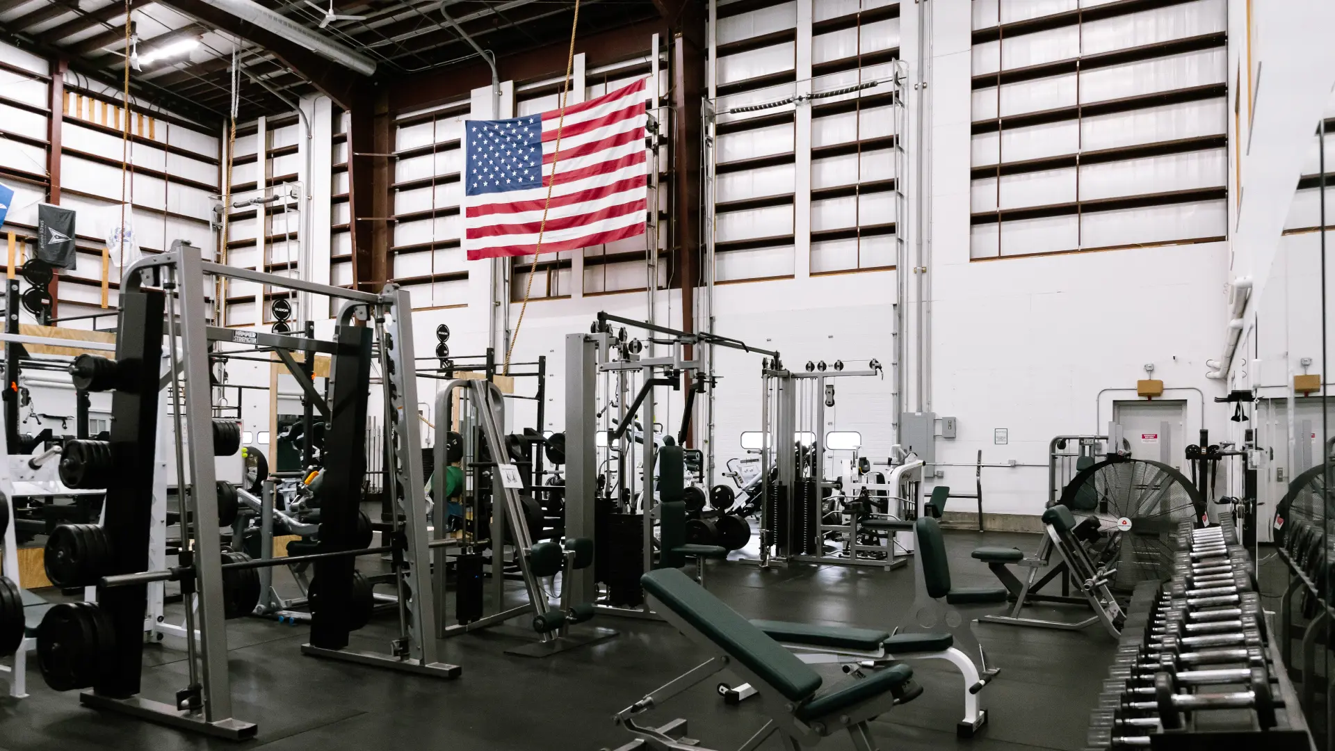 Wide view of the main training floor with machines and dumbbells at O.N. Athletics in Groton, CT