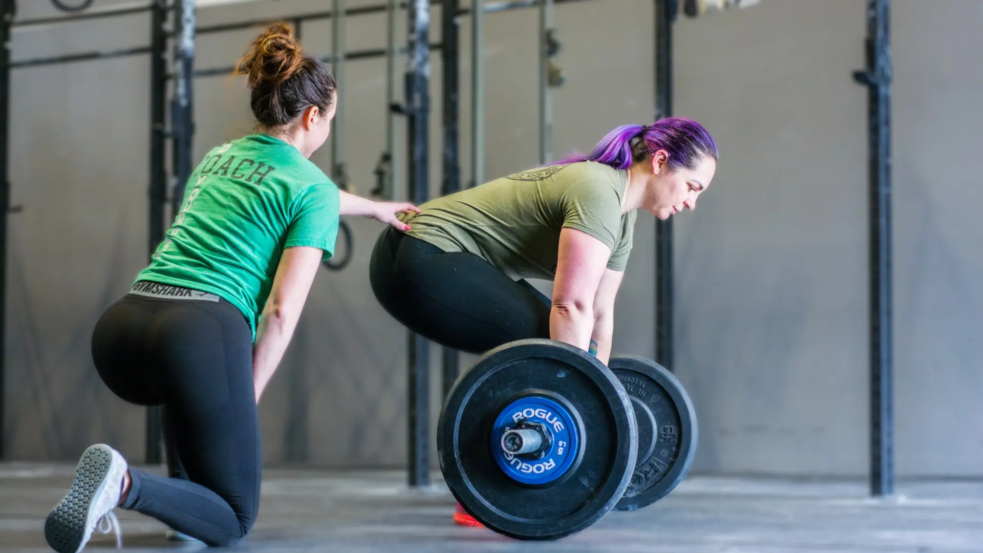Coach cueing a member through a barbell deadlift during a personal training session in Groton, CT